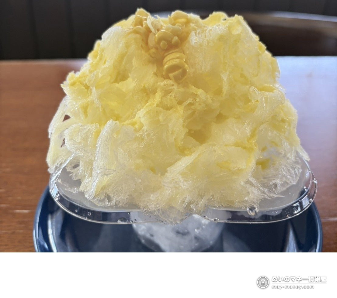 Fluffy yellow shaved ice topped with corn kernels