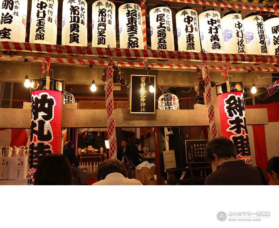 Shrine hall at night decorated with lanterns and red-and-white bunting