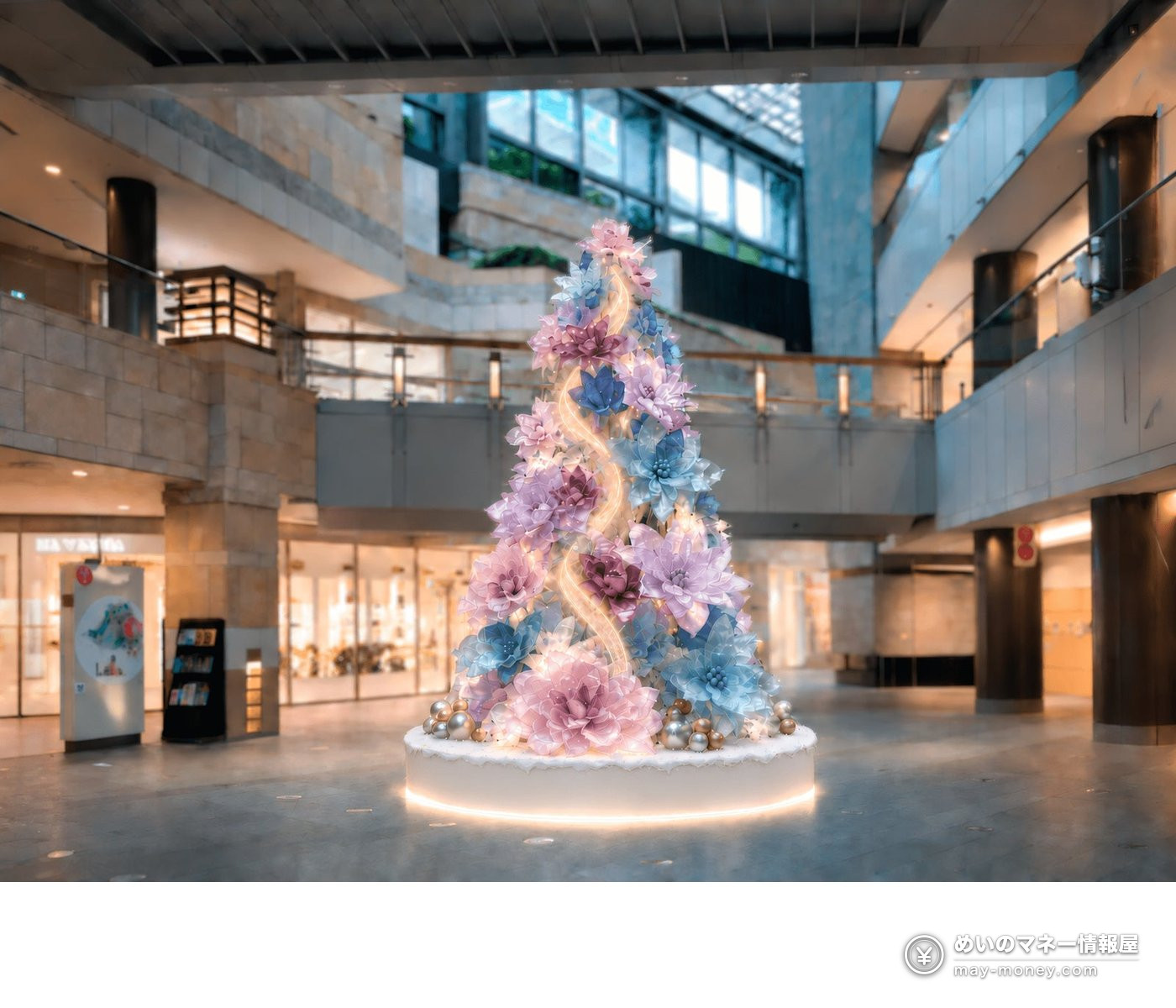 Christmas tree decorated with large pink and blue flowers in an indoor atrium