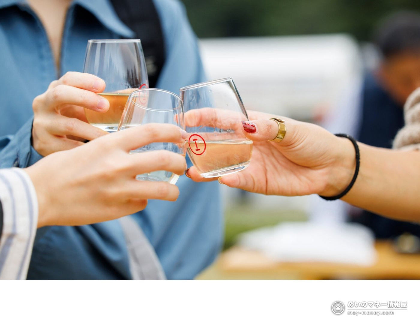 Three people clinking Sake Marche logo glasses