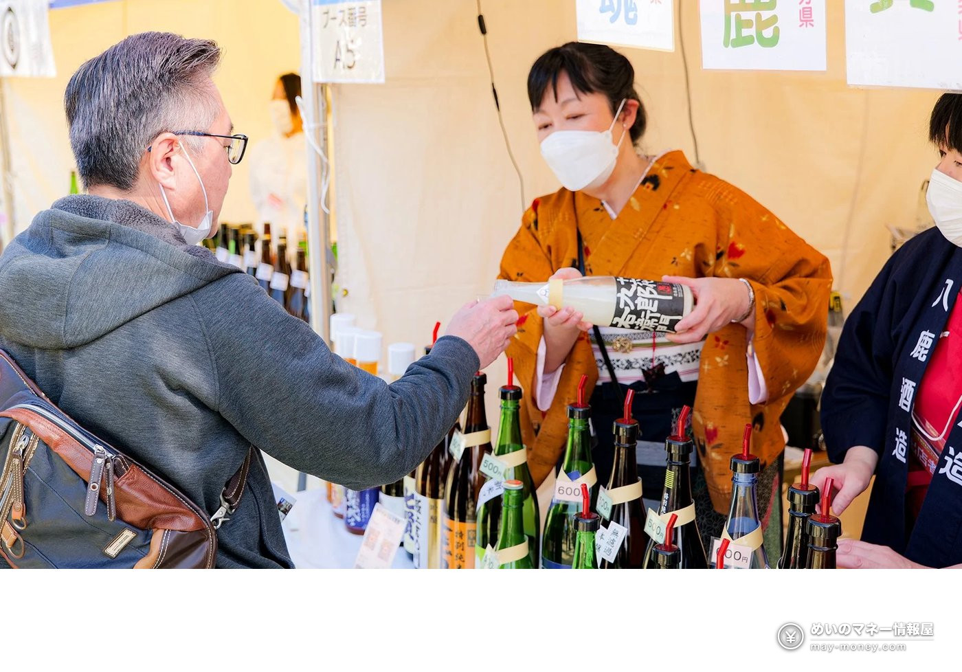 身着和服的工作人员向来场者提供日本酒试饮