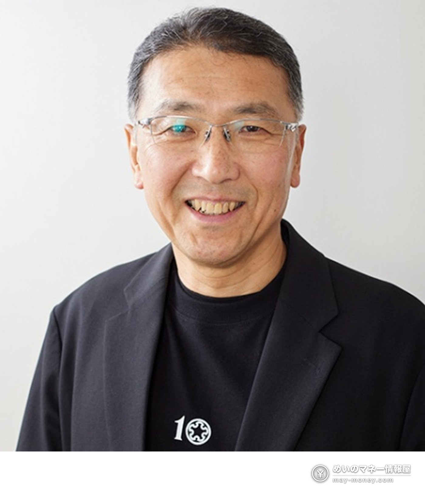 Portrait of a smiling man in glasses and a dark jacket, published with the Hokkaido Sake Brewers Association comment