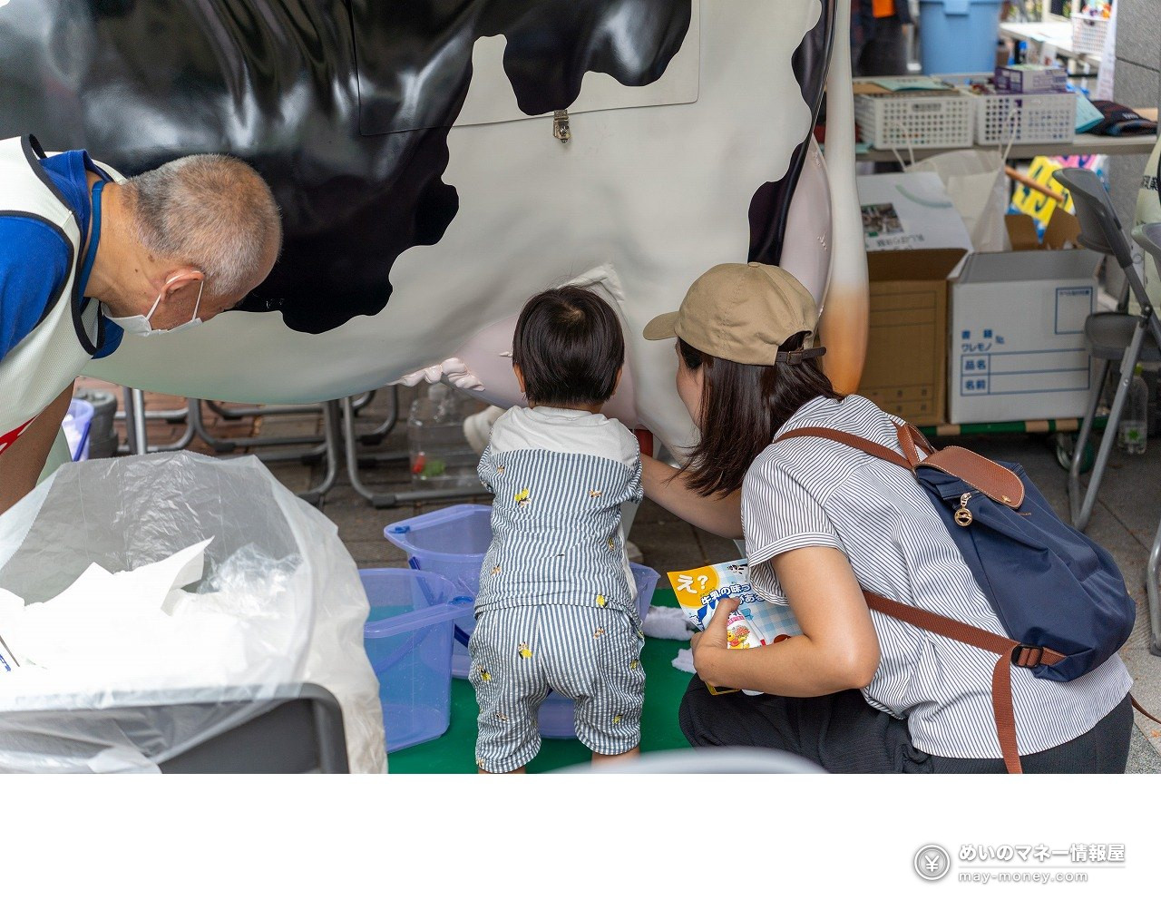 Shibaura Canal Festival 2026: Free Canal Cruise Times & Tips 13 A child trying the milking experience on a model cow