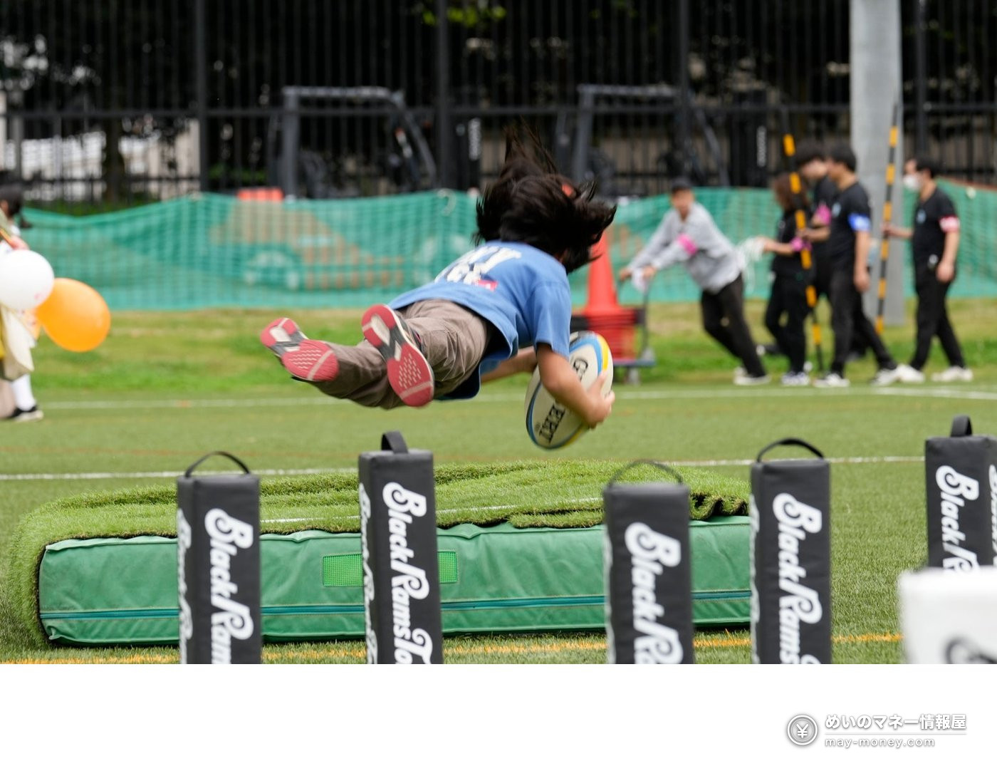 Furusato Shibuya Festival at Yoyogi Park: Free Entry, Akita Dogs, Ponies and 130 Tents (Nov 7–8) 4 A child holding a rugby ball diving onto a mat during a sports activity