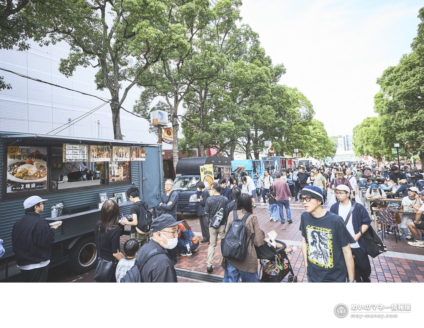 TAMATAMA FESTIVAL 2026: Free Concerts, Food and eSports at Tama Center 3 Food trucks lined up along a tree-lined street with crowds shopping and eating