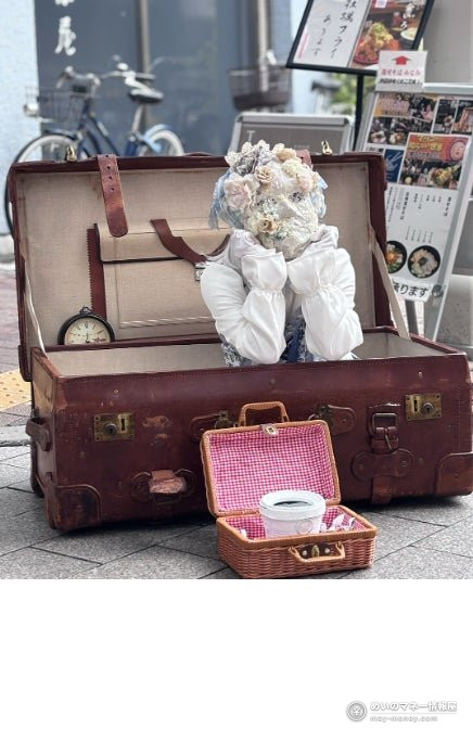 Yokohama VIVRE Halloween Greeting on Oct 31: Horror Cast and Free Sweets 4 An open leather trunk on a street with a white doll decorated with flowers and a small basket