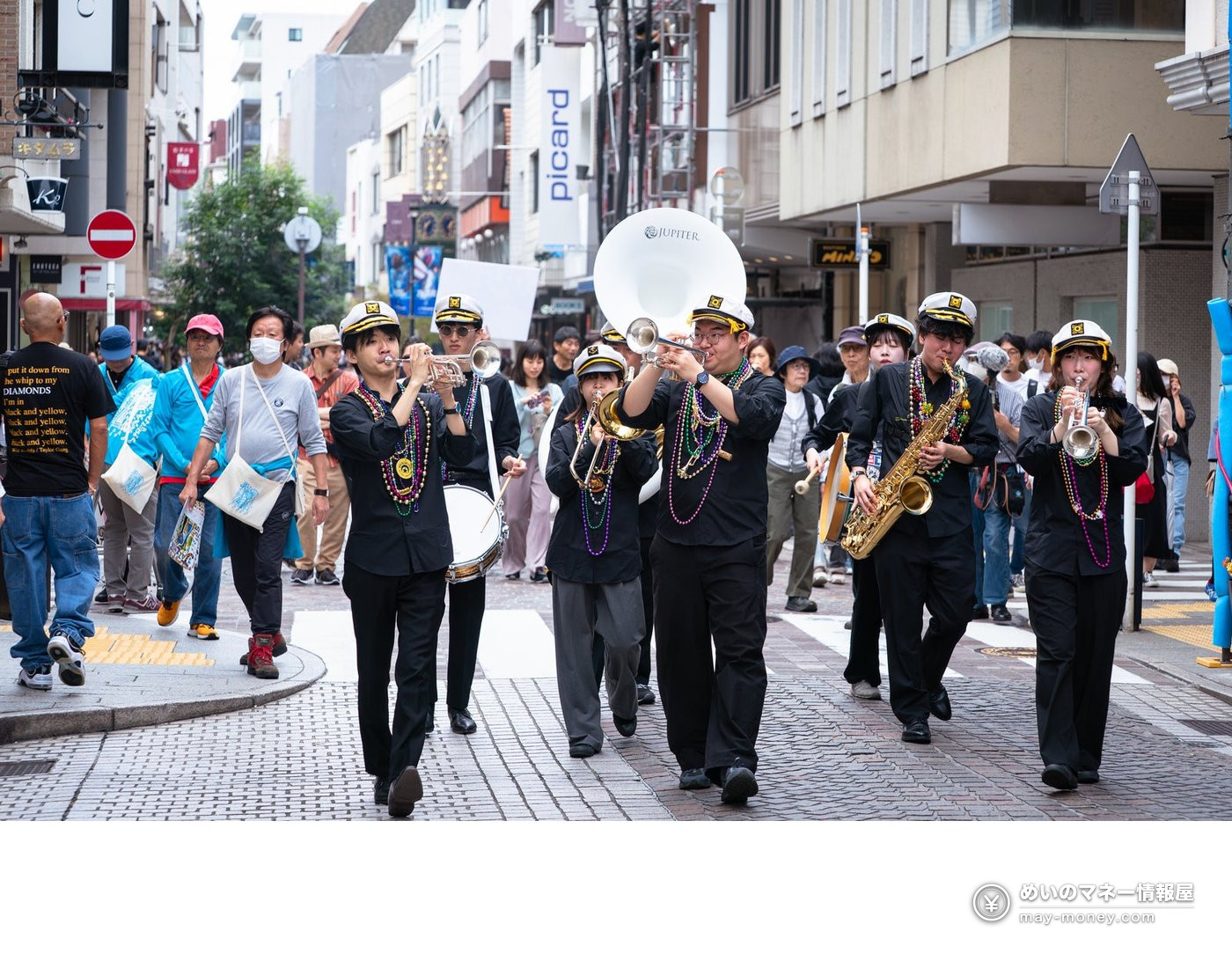 Yokohama Jazz Promenade 2026: Free Street Shows and Tickets 4 A band in black with captain hats marching down a street playing brass instruments
