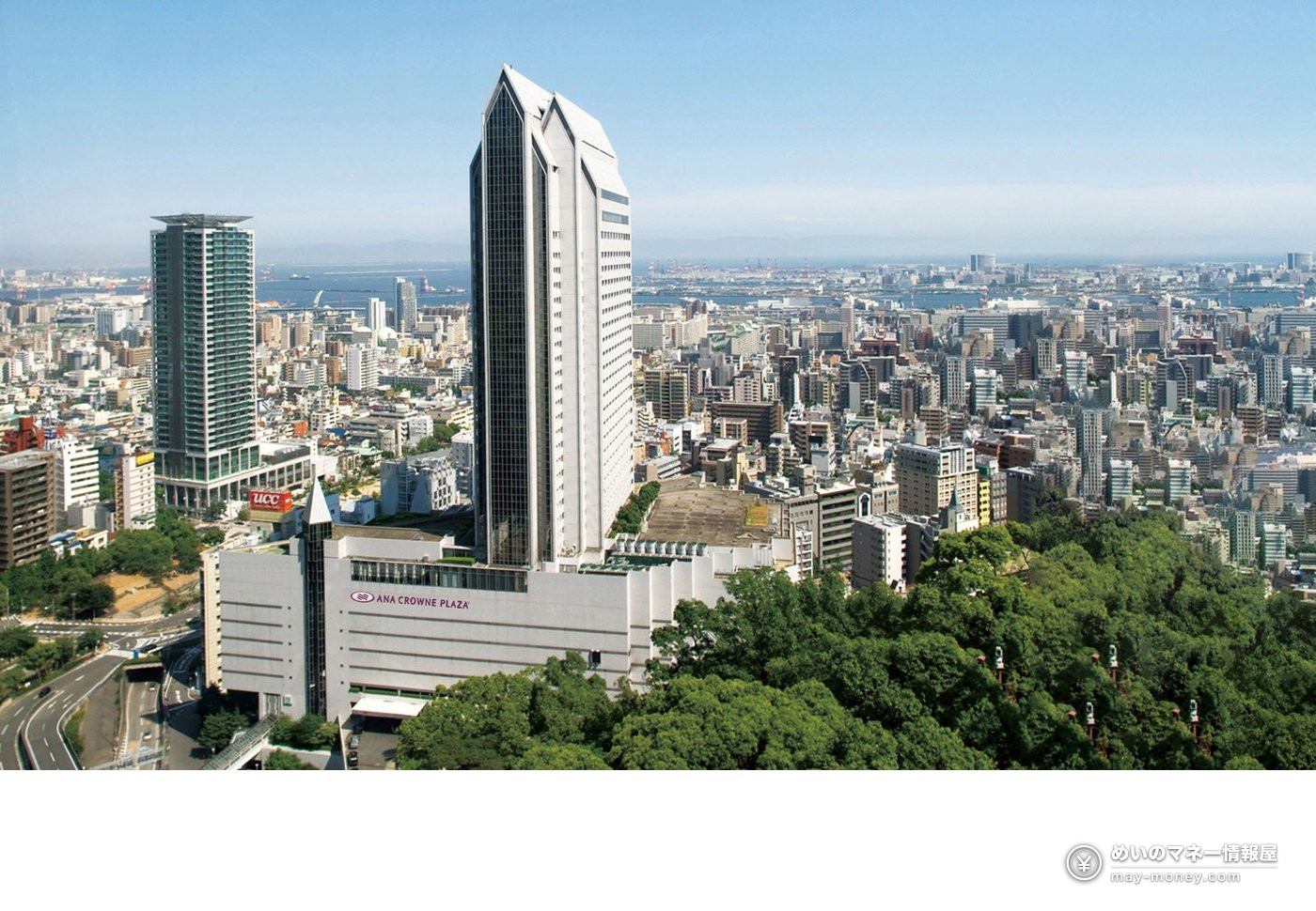 ANA Crowne Plaza Kobe rising above the city with the sea in the distance
