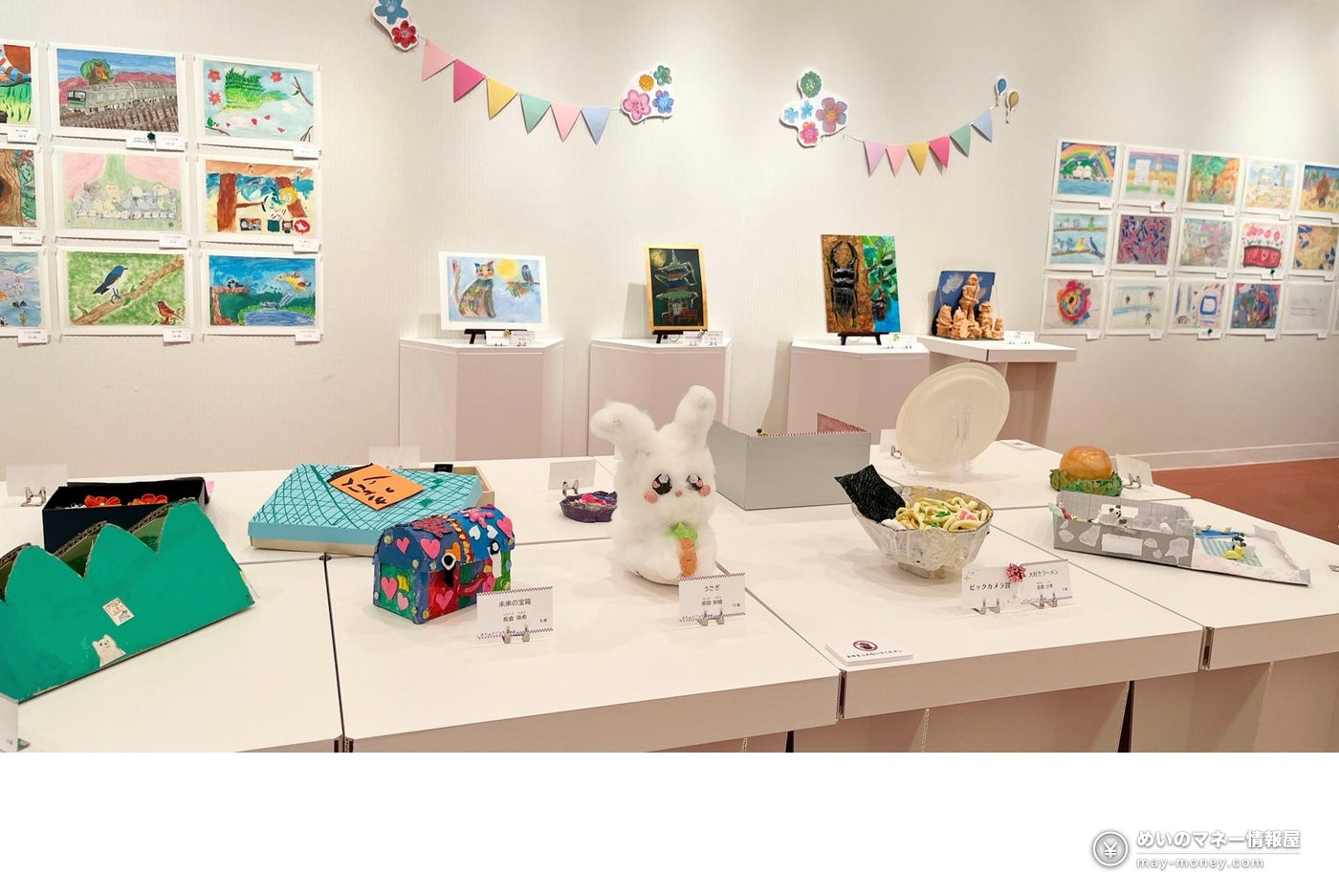 Children’s paintings and craft pieces displayed on walls and tables at last year’s kids art show