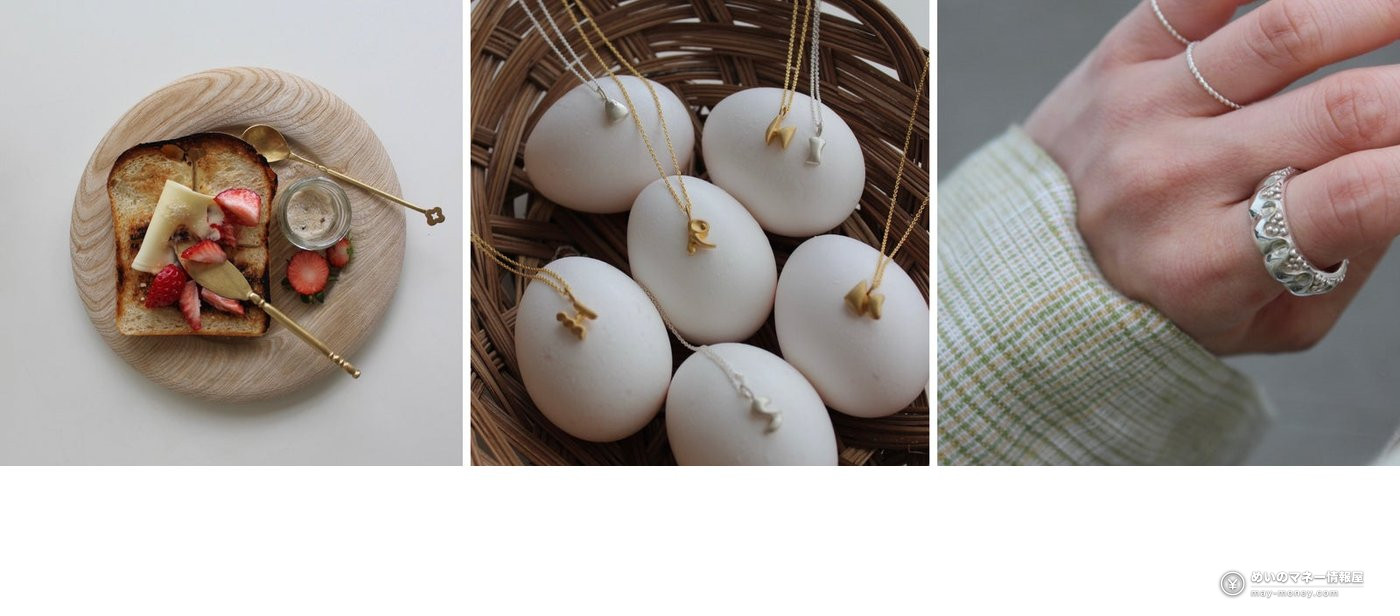 Strawberry toast on a wooden plate, a gold necklace on an egg and a silver ring on a hand