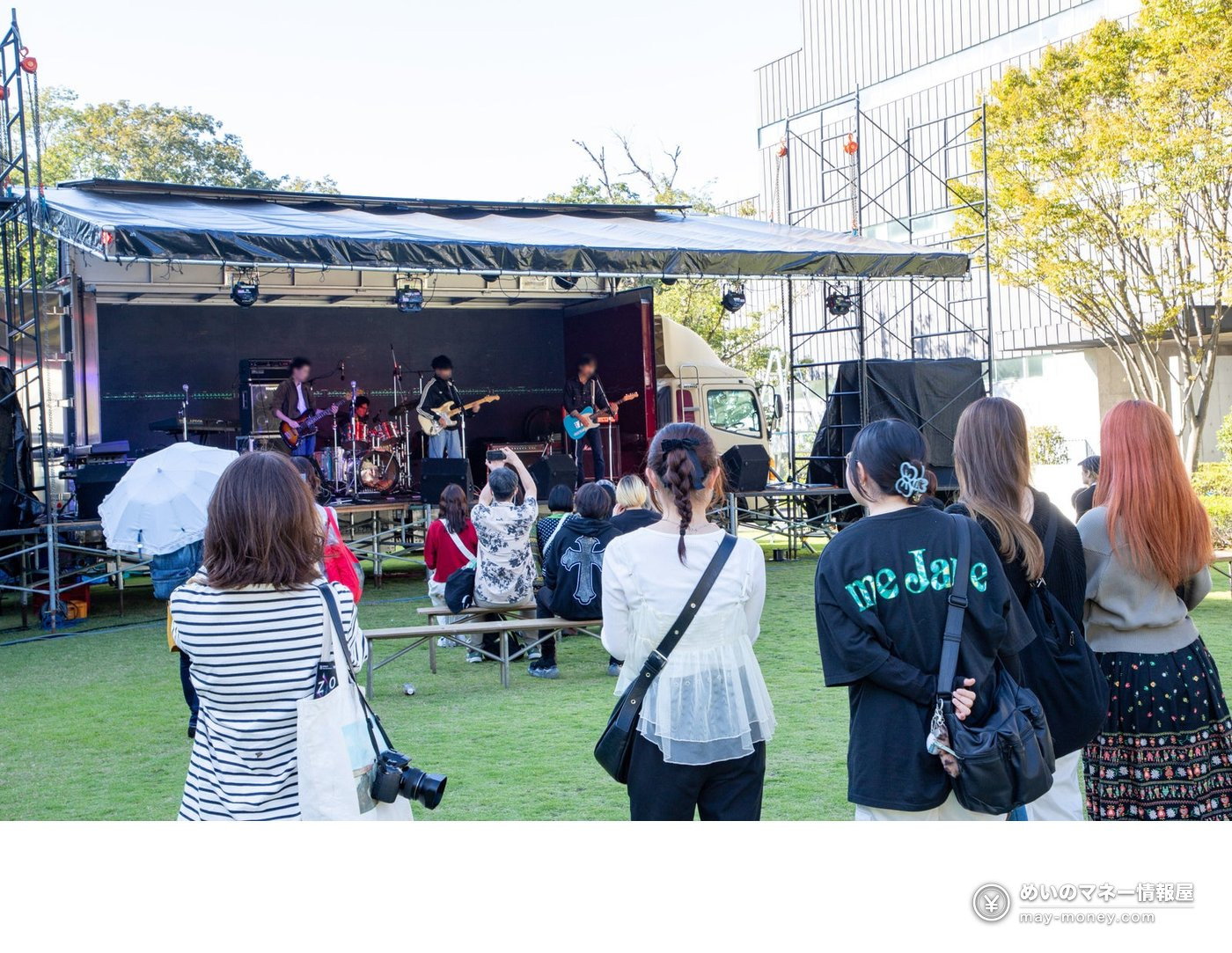 A band performing on an outdoor stage for an audience at the 2025 CS Festival