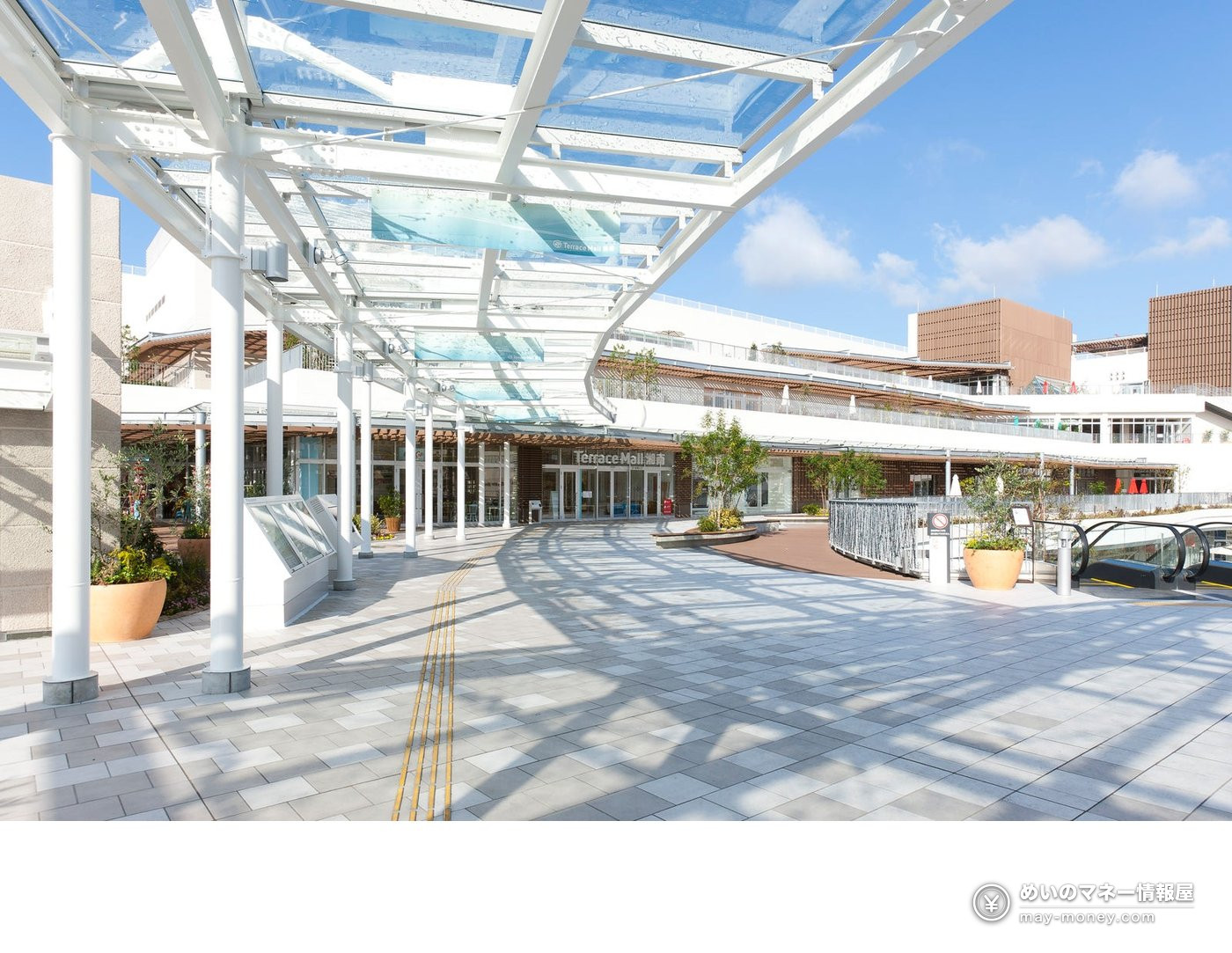 Entrance plaza of Terrace Mall Shonan with a glass roof and white pillars on a sunny day