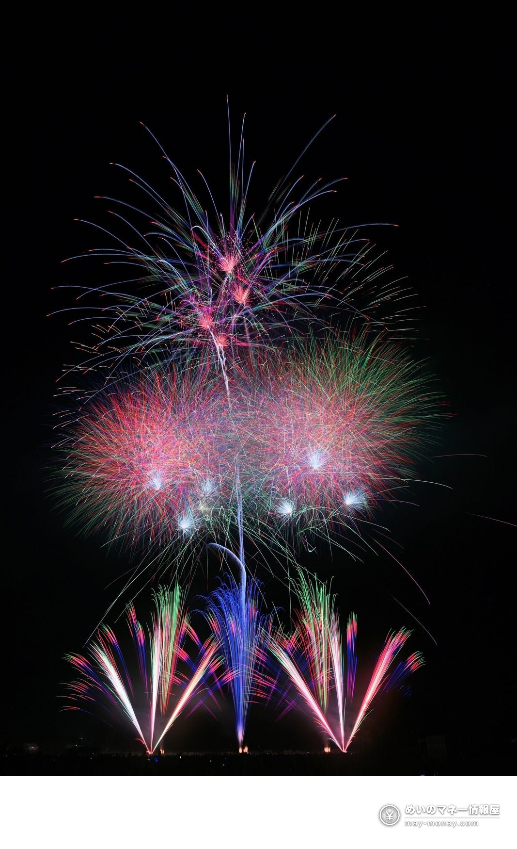 夜空に広がる色とりどりの花火と、地上で噴き出す花火