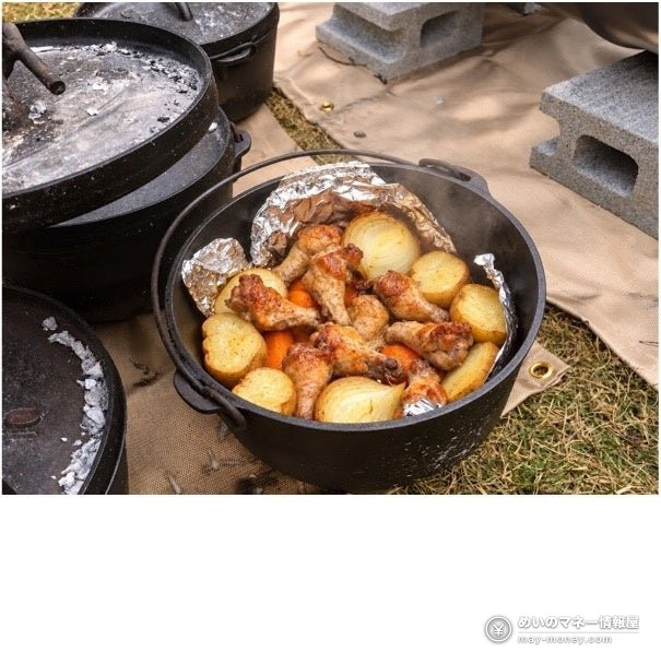 Chicken wings and vegetables cooked in a Dutch oven outdoors