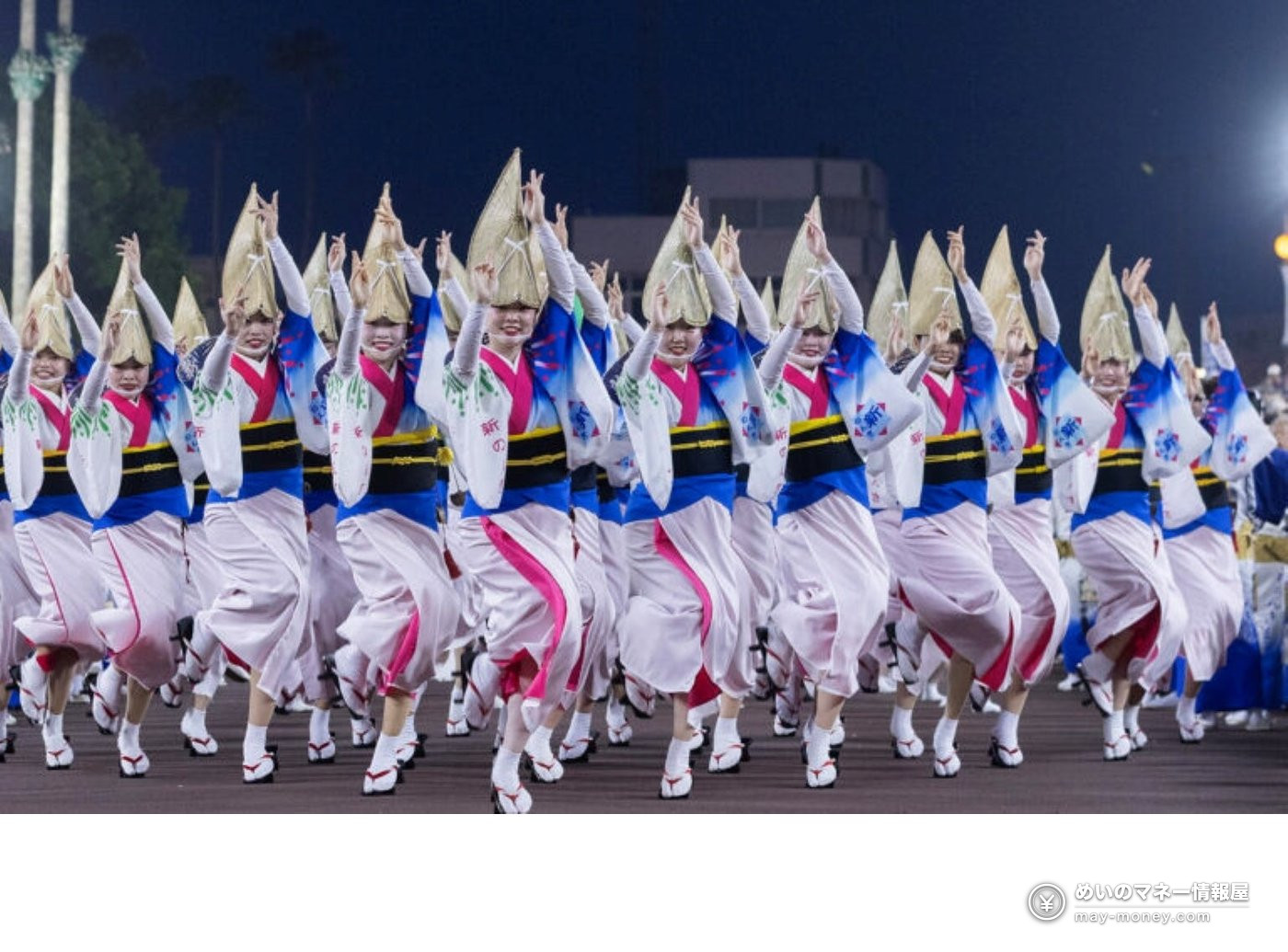 Awa Odori dancers wearing woven hats during a nighttime performance