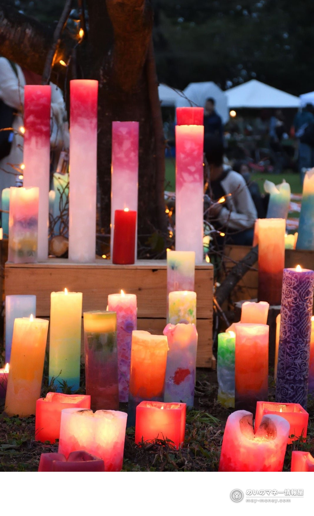 if Inariyama Festa (Oct 11): Free Charity Festival and Candle Night in Sayama 3 Colorful candles on wooden crates and the ground, with tents and visitors in the background