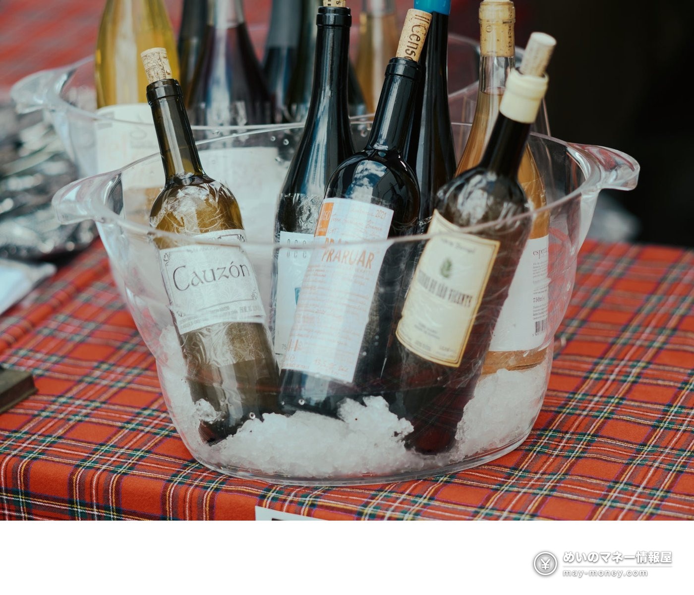 Wine bottles chilling in a clear container filled with ice