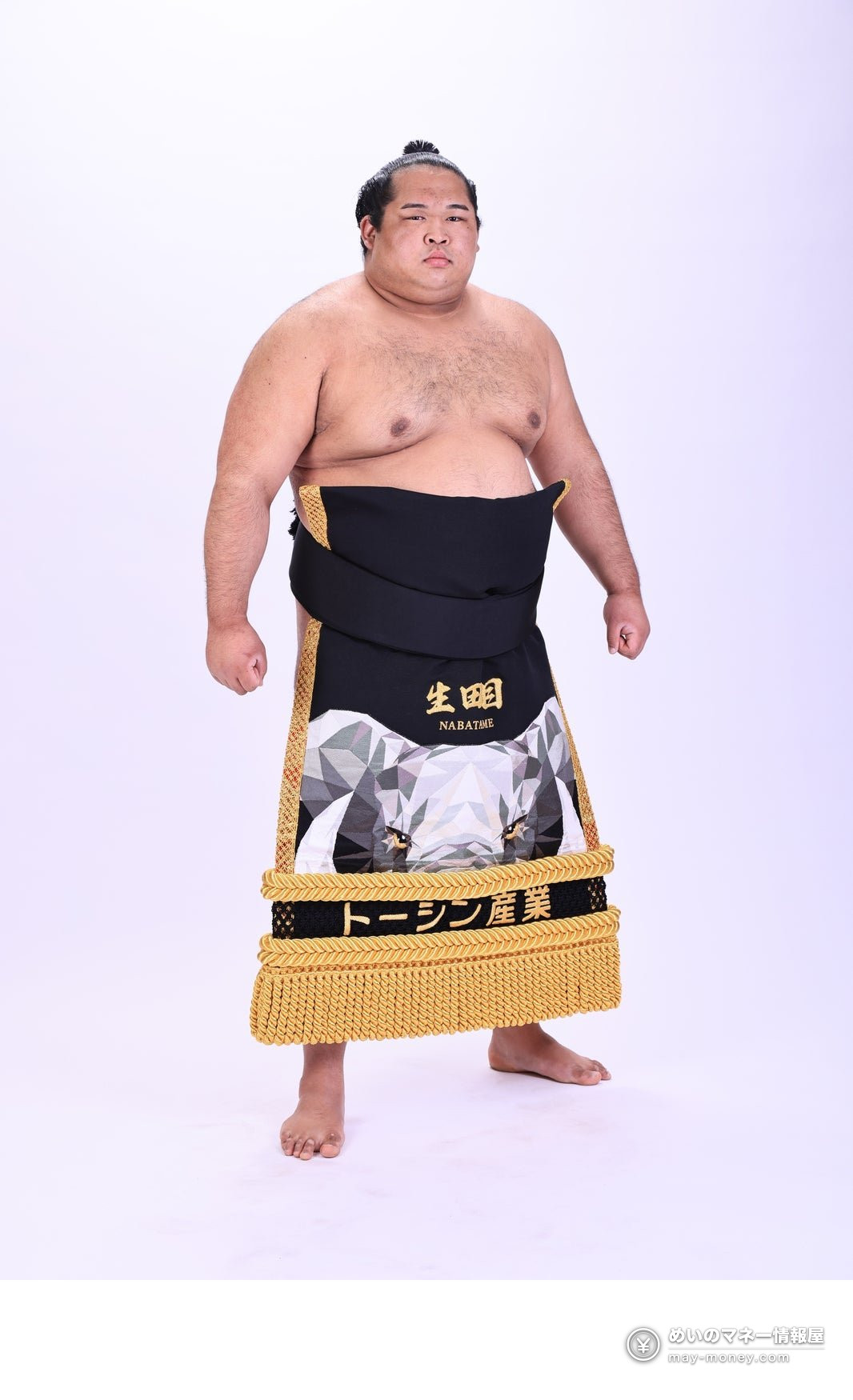 Sumo wrestler Namatame standing in a black ceremonial apron