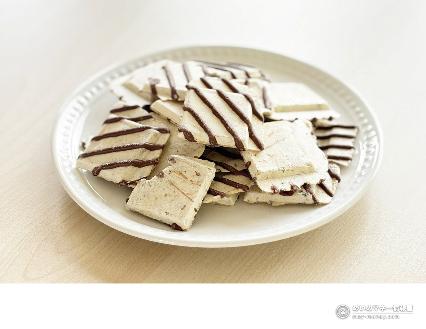 Flat sweets with chocolate stripes on a white plate